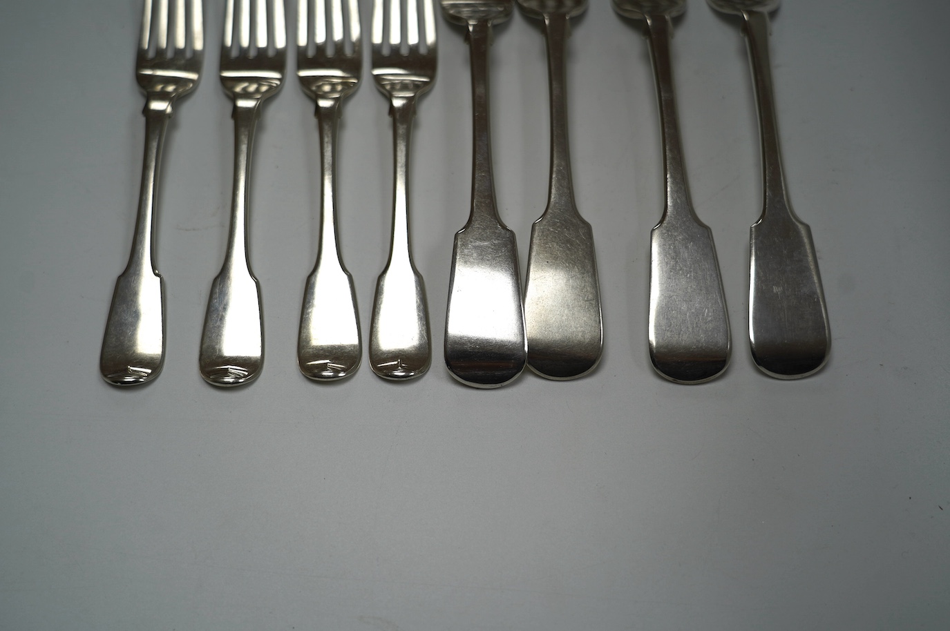 A pair of William IV silver fiddle pattern sauce ladles, William Eaton, London, 1834, 18.1cm, a set of four Victorian silver fiddle pattern table forks, Exeter, 1838 and a set of four George III silver dessert forks, Lon